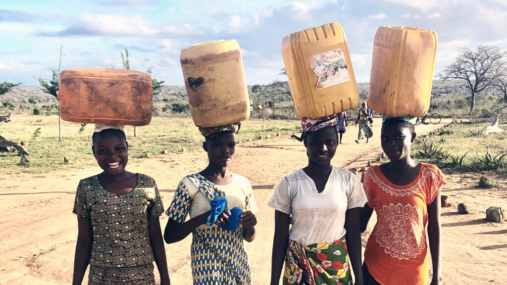 kenya_women carrying water canisters on head_49479593636_1952ca6f0f_o copy_thumbnail